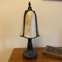 Full view of lamp unlit showing slag glass shade and ornate metal base