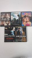 Five DVDs shown from front with cover art visible: The Last King of Scotland, Tigerland, The Inbetweeners Movie, The Insider, Walk the Line