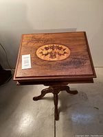 Full front view of entire table showing pedestal base and tabletop