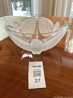 Front view of crystal bowl showing a raised frosted dove with outstretched wings.