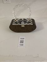 Front view of a brown and clear Lucite vintage handbag with faceted handle and clasp closure.