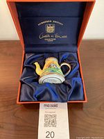 Miniature tea pot displayed in original blue lined box, showing Charlotte di Vita branding