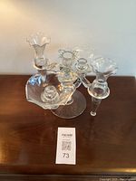 Full top-front view of the vintage Cambridge glass arm candelabra on a wooden surface, showing all arms, bud holders, and central candlestick holder.