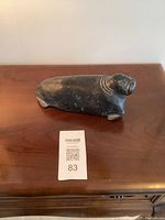 Front view of the soapstone walrus carving showing the overall shape and details on the face and body.