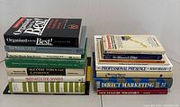 Photo shows two stacks of books related to finance, sales, marketing, and management, totaling 16 books.