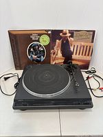 Front view of Onkyo turntable with two vinyl record albums behind, one by John Dawson Read, the other by J.D. Miller.