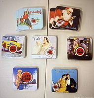 Overview photo showing 9 vintage Lucky Strike cigarette tins with seven different design styles, including one Santa-themed tin.