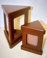 Two triangular wooden containers with brown finish showcasing transparent window panels, one large and one medium sized.