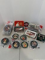 Full assortment of vintage Coca-Cola tin coasters in original packaging and retail boxes displayed on white background.