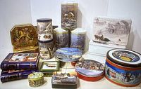 Full view of all 18 assorted Christmas tins with various shapes and holiday town scenes