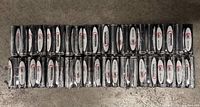Photo showing 50 AA batteries in their original sealed packaging arranged in two rows on a concrete floor.