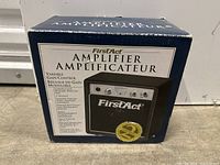 Photo of FirstAct amplifier box with product image and details visible.