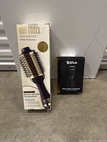 Hot Tools Pro Artist round hair volumizing brush in white and gold box next to Telfun Body Hair Trimmer box