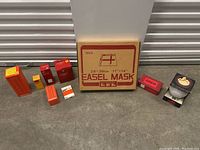 Vintage photography supplies including multiple boxed film developing chemicals, accessories and an easel mask