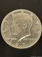 Front side of 1971 John F. Kennedy half dollar coin showing the bust and inscriptions.