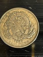 Reverse side of the token showing '1844' year, 'HALF PENNY' denomination, and wreath design around a central 'X' symbol.