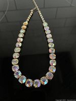 Full view of the Aurora Borealis stone necklace showing all stones hand set in metal claw prongs on a 16-inch chain length.