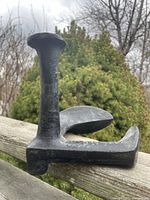 Close-up of large cast iron shoe repair anvil showing overall form and condition.