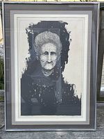 Framed lithograph featuring a portrait of an elderly woman, titled 'Rebecca'.