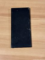 Front side of the Samsung Galaxy Note 20 showing cracked display screen and overall black color phone.