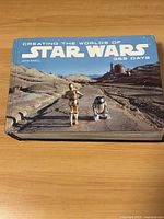 Front cover of the hardcover book featuring Star Wars, with characters C-3PO and R2-D2 prominently shown.