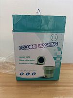 Original box of the folding washing machine showing product details and image.
