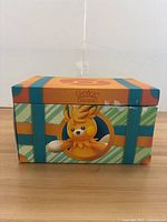 Closed Pokémon chest box showing Paldea-themed art and Victini.