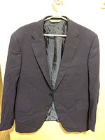 Front view of blue men's jacket size 42 with flap pockets and two-button closure.
