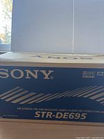 Sony STR-DE695 box front showing model name and brand.