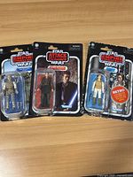 Three sealed Star Wars action figures in blister cards: Anakin Skywalker and two Luke Skywalker figures from different Star Wars movie lines.