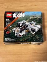 Front view of sealed LEGO Star Wars set box with The Razor Crest spaceship and number of pieces (98).