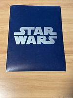 Front cover of the blue Star Wars folder with silver Star Wars logo