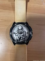Front of Star Wars Stormtrooper watch showing character on dial and white band.