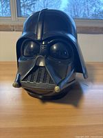 Front view of vintage Darth Vader helmet and mask showing detailed front grill and eye lenses.