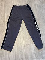 Full view of vintage Jordan joggers laid flat showing elastic waistband, side pockets, and tapered leg design.