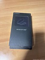 Front view of new sealed Casekoo MagicStand wireless phone holder box showing logo and graphic.