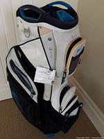 Side angle of Nike Performance golf bag showing front and side zippered compartments, club dividers, and handle