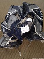 Photo of the used Reebok hockey goalie set showing pads, blocker, and glove piled together with visible wear.