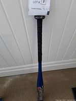 Photo showing full length of blue Ignitor baseball bat with black grip tape on handle and branded graphics.