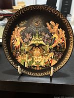 Front view of the plate showing the detailed hand-painted artwork depicting the fisherman and the magic goldfish scene with gold detailing and decorative border.