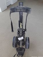 Full view of Bag Boy M-300 golf cart showing frame, wheels, support, and straps.