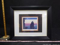 Full view of the framed limited edition art print showing coastal rock formations and sunset sky.