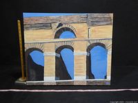 Front view of canvas painting showing Roman arches with sky background, measuring about 20 inches high.