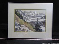 Front view of framed watercolour depicting a mountainous landscape with trees and snow.