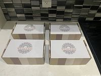 Four closed gift boxes branded Wellcense arranged on a countertop