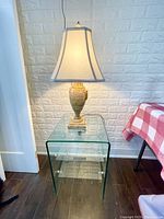 Front view of table and lamp against wall