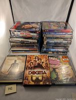 Photo showing stacked DVDs and three front-facing DVD cases (Gladiator, Dogma, Fight Club)