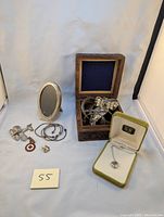 Various sterling and Mexican silver items: pins, bracelets, small picture frame in wooden box, necklace in jewelry box.