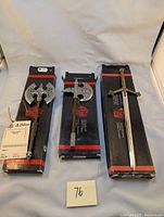 Three Denix miniature replica weapons in original boxes, including two axes and one sword.