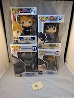 Four Funko Pop boxes displayed: Ichigo Kurosaki #59 (Bleach), Sasuke Uchiha #72 (Naruto Shippuden), Winston #97 and Tracer #92 (Overwatch).